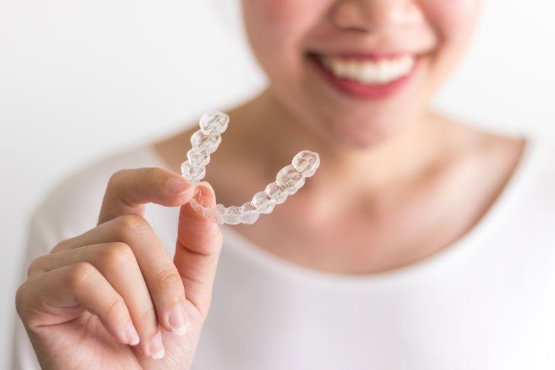 Woman holding her Invisalign